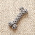Load image into Gallery viewer, Nodo knotted cotton rope bone on a cream wool rug seen from above