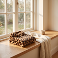 Load image into Gallery viewer, St. Moritz Leopard Hoodie folded on an oak window seat