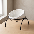 Load image into Gallery viewer, Onda Raised Bowl in White, tilted ceramic bowl on a black wire stand