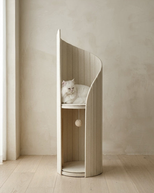 ARCHE in Cream in a plaster-walled room, a white long-haired cat resting on the upper perch, with the lower alcove and hanging pom-pom toy below