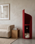 Load image into Gallery viewer, ARCHE in Coral Red beside a low linen sofa, showing its height against the furniture

