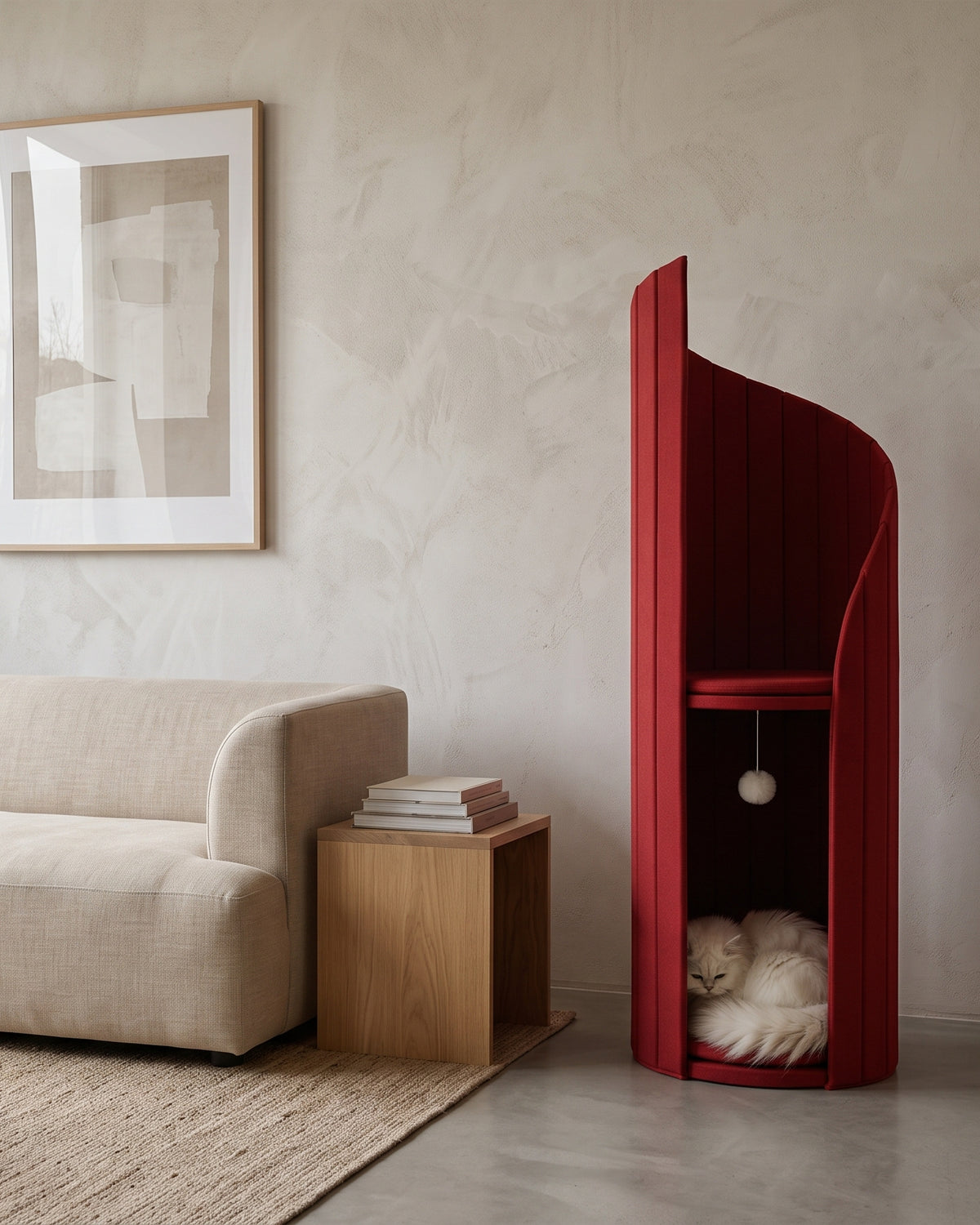 ARCHE in Coral Red beside a low linen sofa, showing its height against the furniture