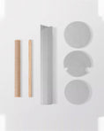 Load image into Gallery viewer, The ARCHE parts laid out before assembly: two sisal posts, the fluted panel and three felt platforms

