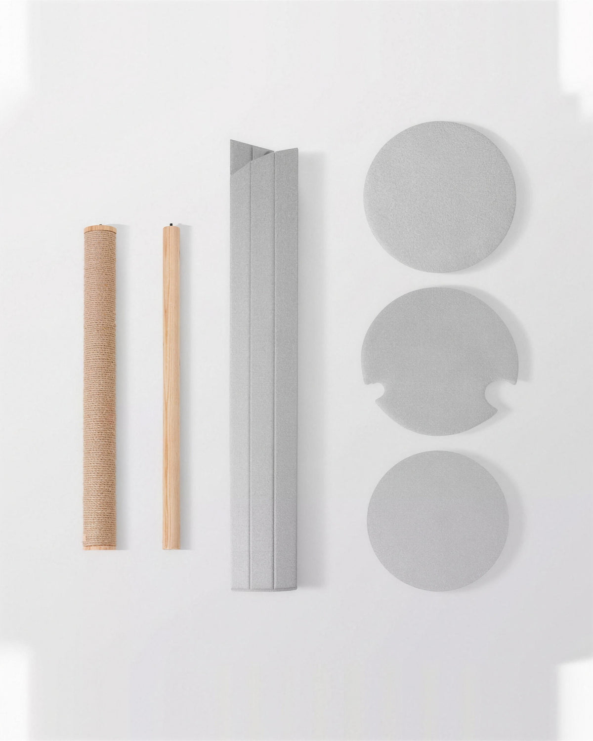 The ARCHE parts laid out before assembly: two sisal posts, the fluted panel and three felt platforms