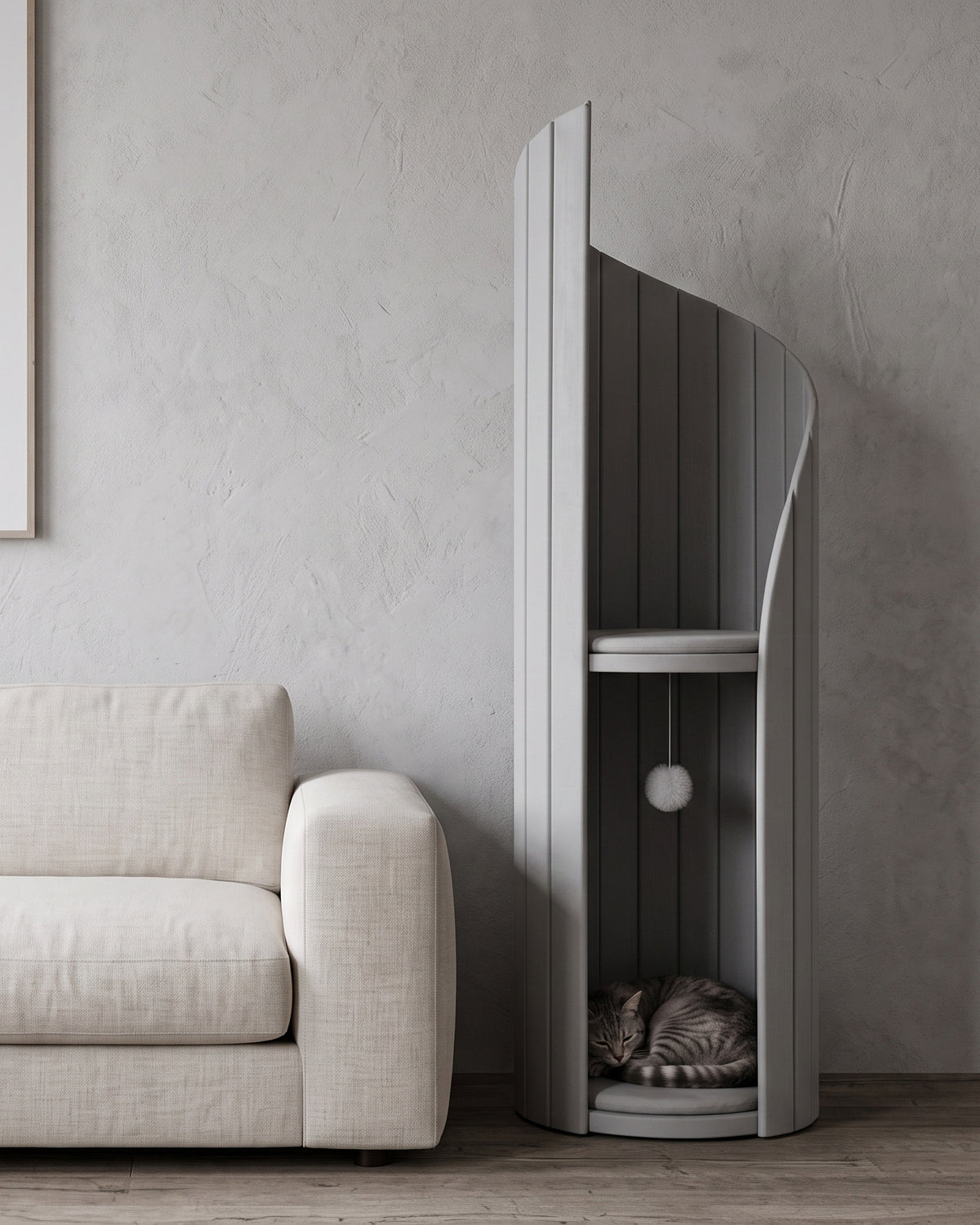 ARCHE in Gray beside a low linen sofa, showing its height against the furniture, with a cat curled in the lower alcove