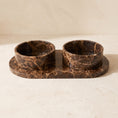 Load image into Gallery viewer, Castaño Pet Bowl Set: two dark Emperador marble bowls on an oval marble tray
