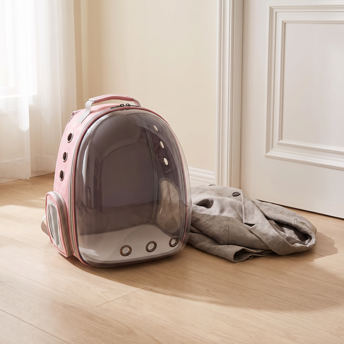 Vista Pet Carrier resting on a pale oak floor beside a doorway