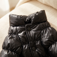 Load image into Gallery viewer, Close view of the Verbier Puffer Suit stand collar, snaps and channel quilting
