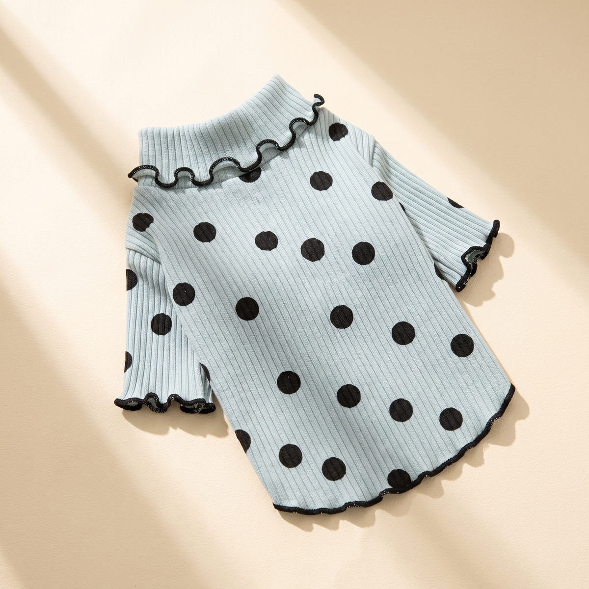 Megève Dot Knit in sky blue laid flat on a cream background