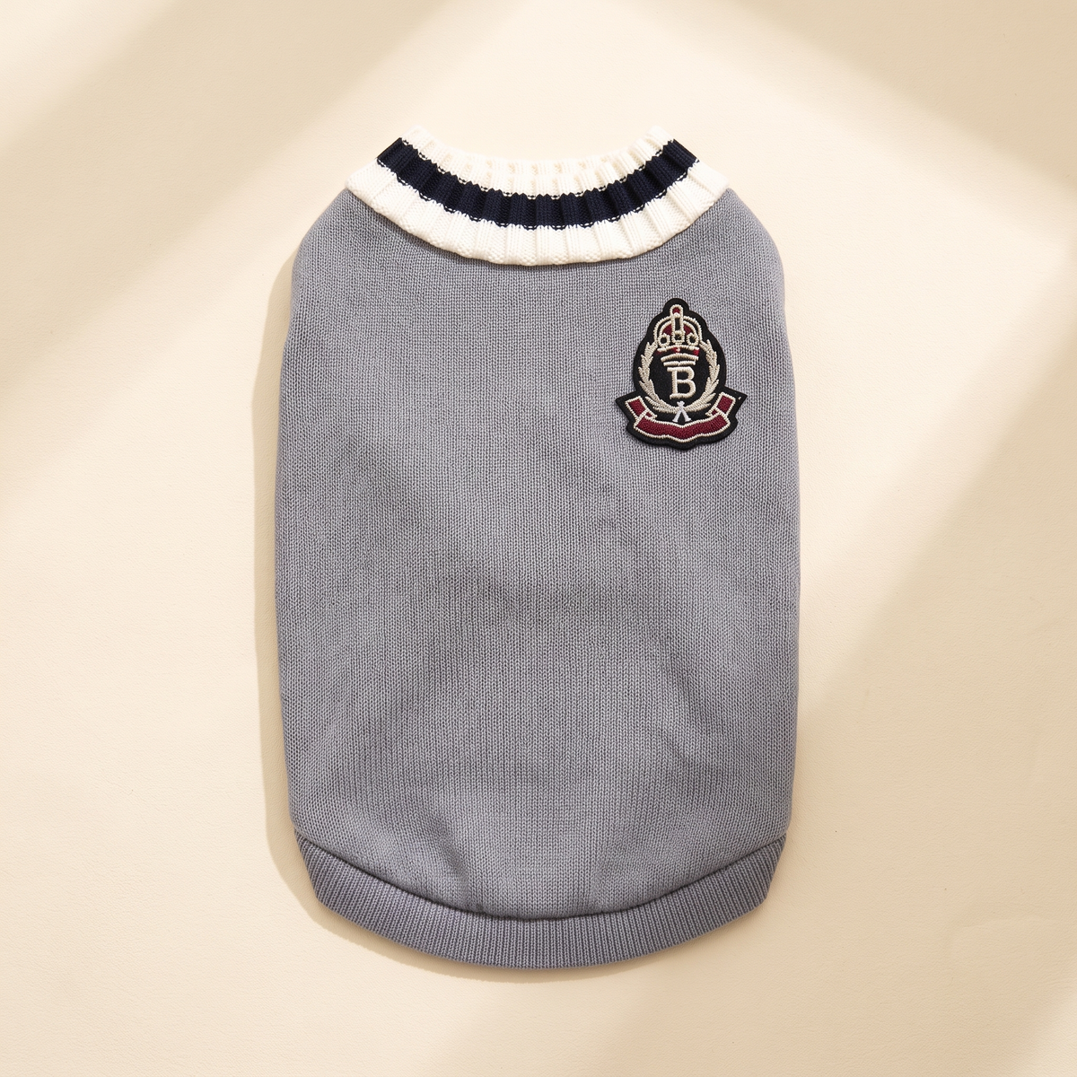 Cortina Varsity Knit in gray laid flat on a cream background