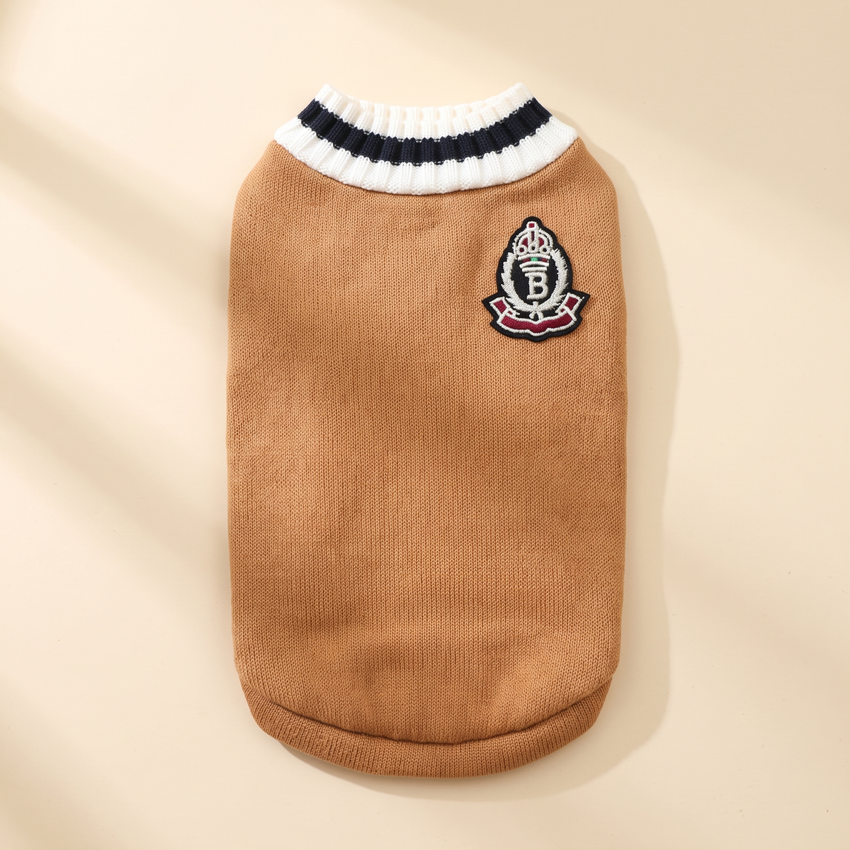 Cortina Varsity Knit in camel laid flat on a cream background