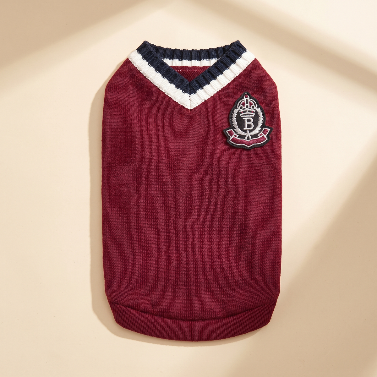 Cortina Varsity Knit in burgundy laid flat on a cream background