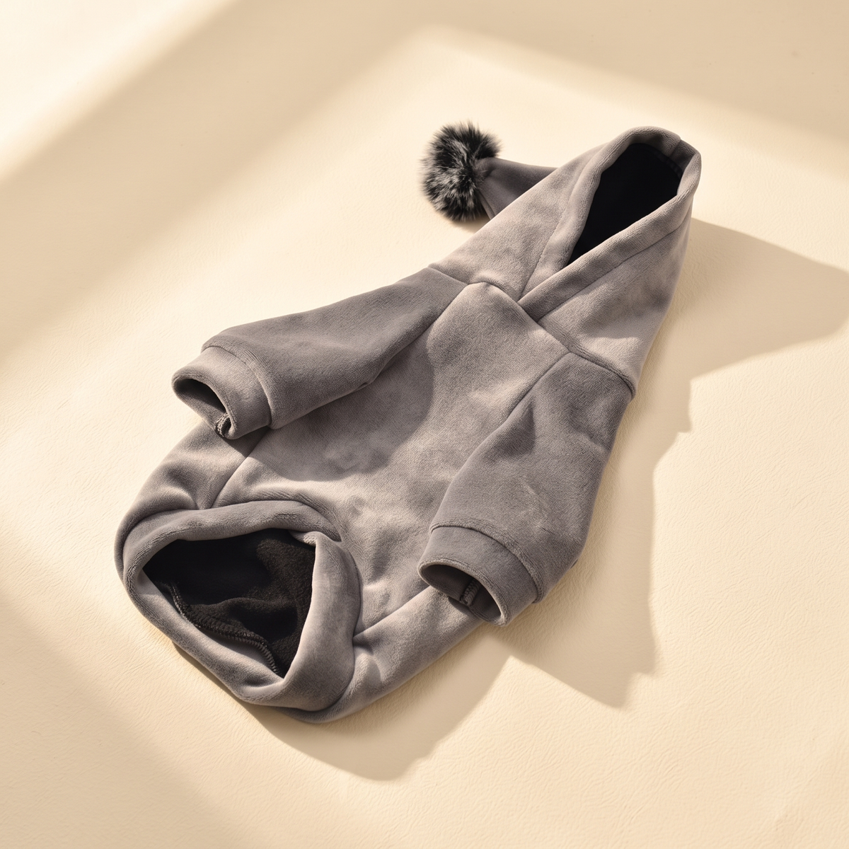 Gstaad Velour Hoodie in gray laid flat on a cream background