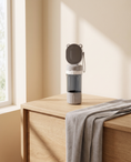 Load image into Gallery viewer, Arno Travel Bottle on a pale oak console beside a folded linen runner
