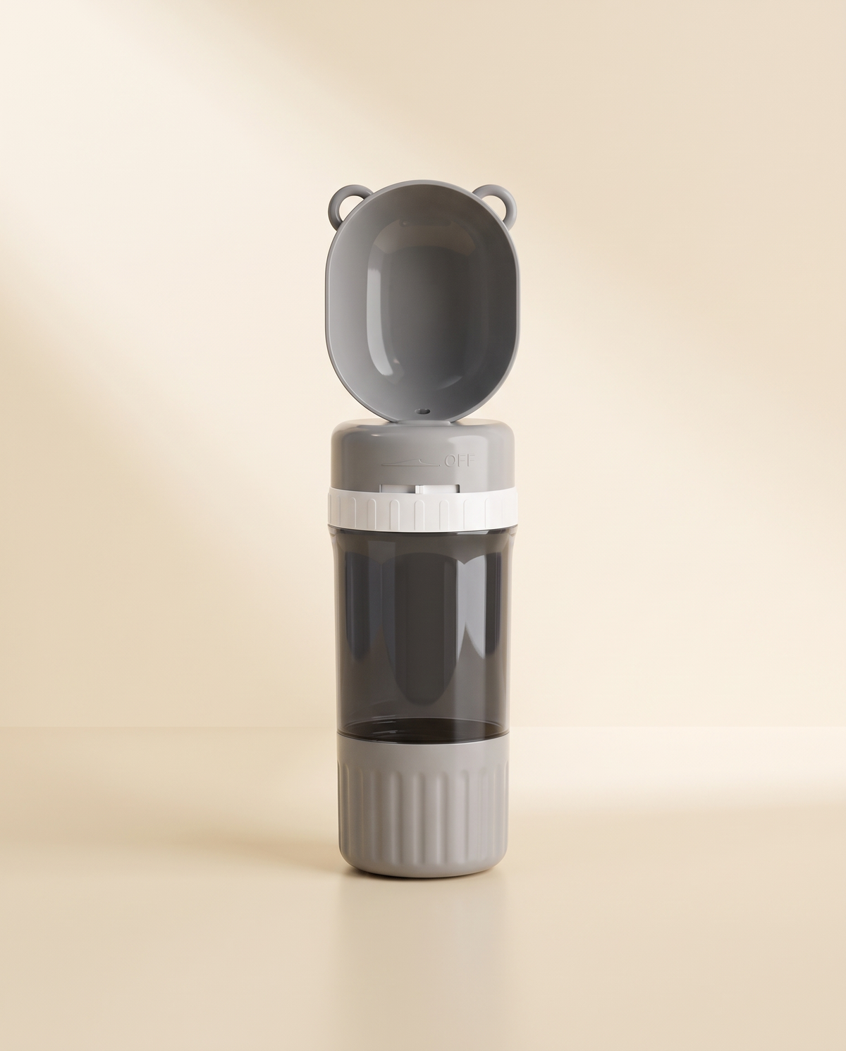 Arno Travel Bottle in gray, cup open, shown against a warm cream backdrop