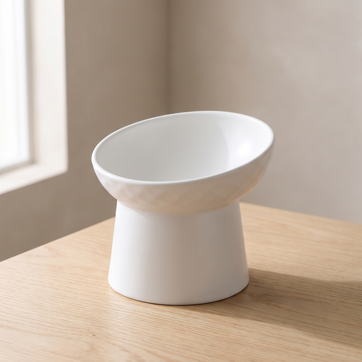 Pendio Raised Bowl in White, the tilted rim shown from a low angle
