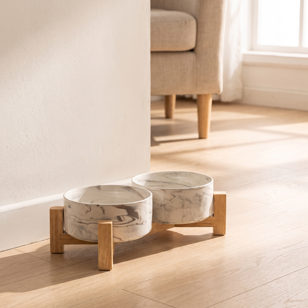 Carrara Pet Bowl Set on an oak floor beside a linen armchair in morning light