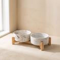 Load image into Gallery viewer, Carrara Pet Bowl Set, two marbled porcelain bowls in a low wood stand

