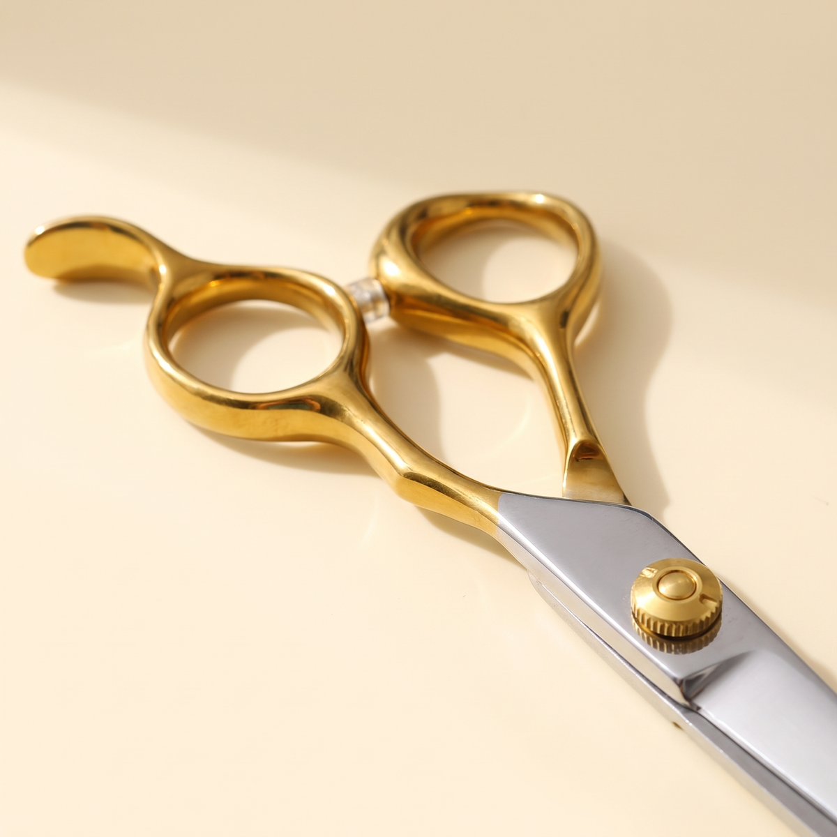 Close view of the gold handles and pivot screw on the Aurea shears
