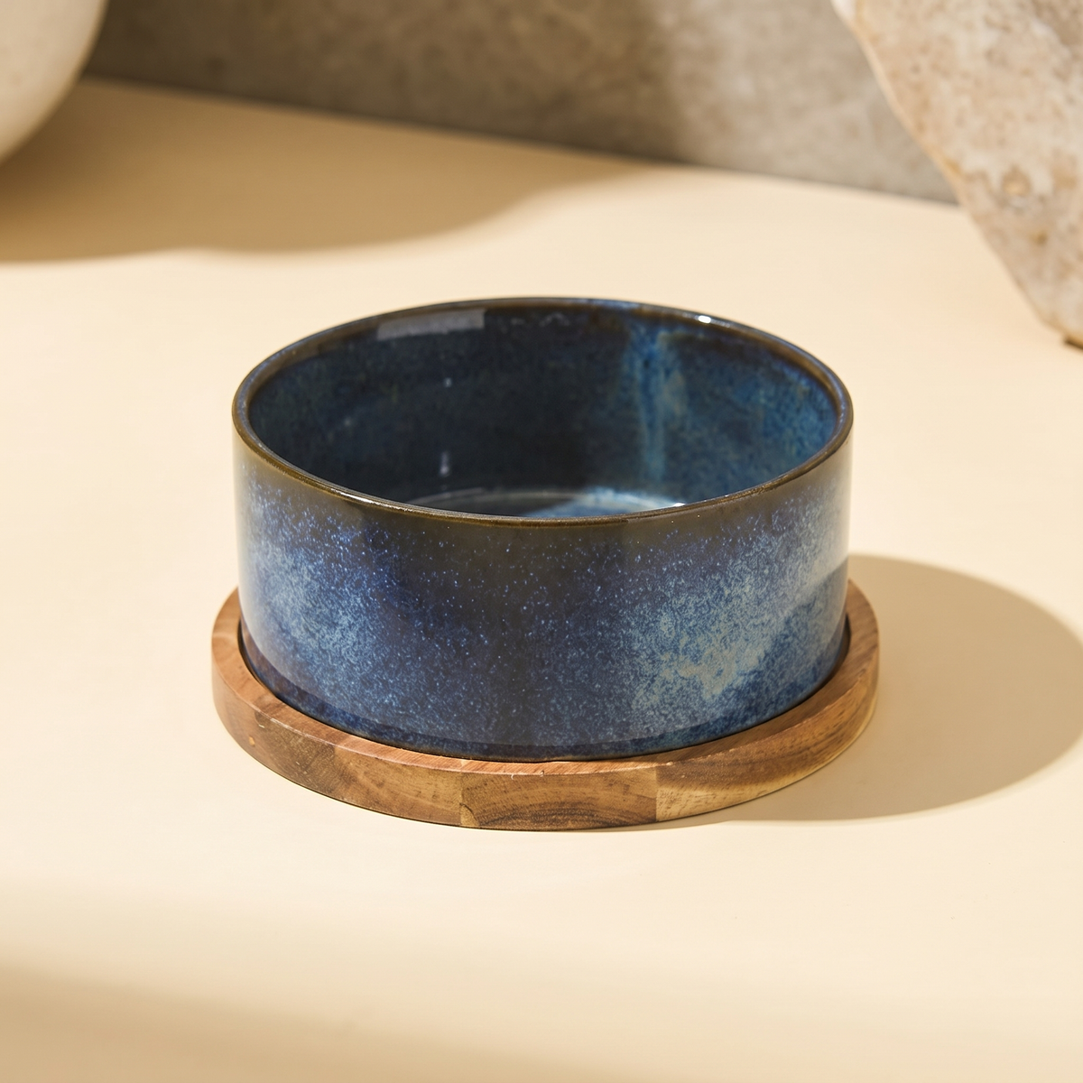 Riva Bowl, Single configuration in the Indigo reactive glaze on a round solid wood base