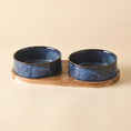 Load image into Gallery viewer, Riva Bowl, Double configuration in the Indigo reactive glaze, two ceramic bowls seated in a solid wood tray
