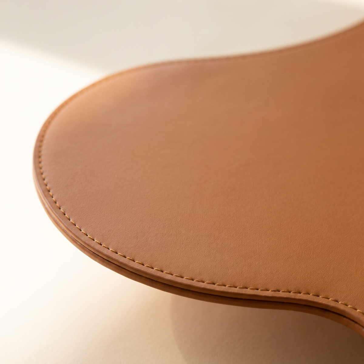 Close view of the Beaumont edge showing the stitch line and the cut edge of the panel