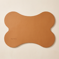 Load image into Gallery viewer, Beaumont Placemat seen from overhead, bone-shaped tan vegan leather with edge stitching
