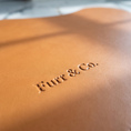 Load image into Gallery viewer, Close view of the debossed Furr & Co. wordmark on the Beaumont Placemat
