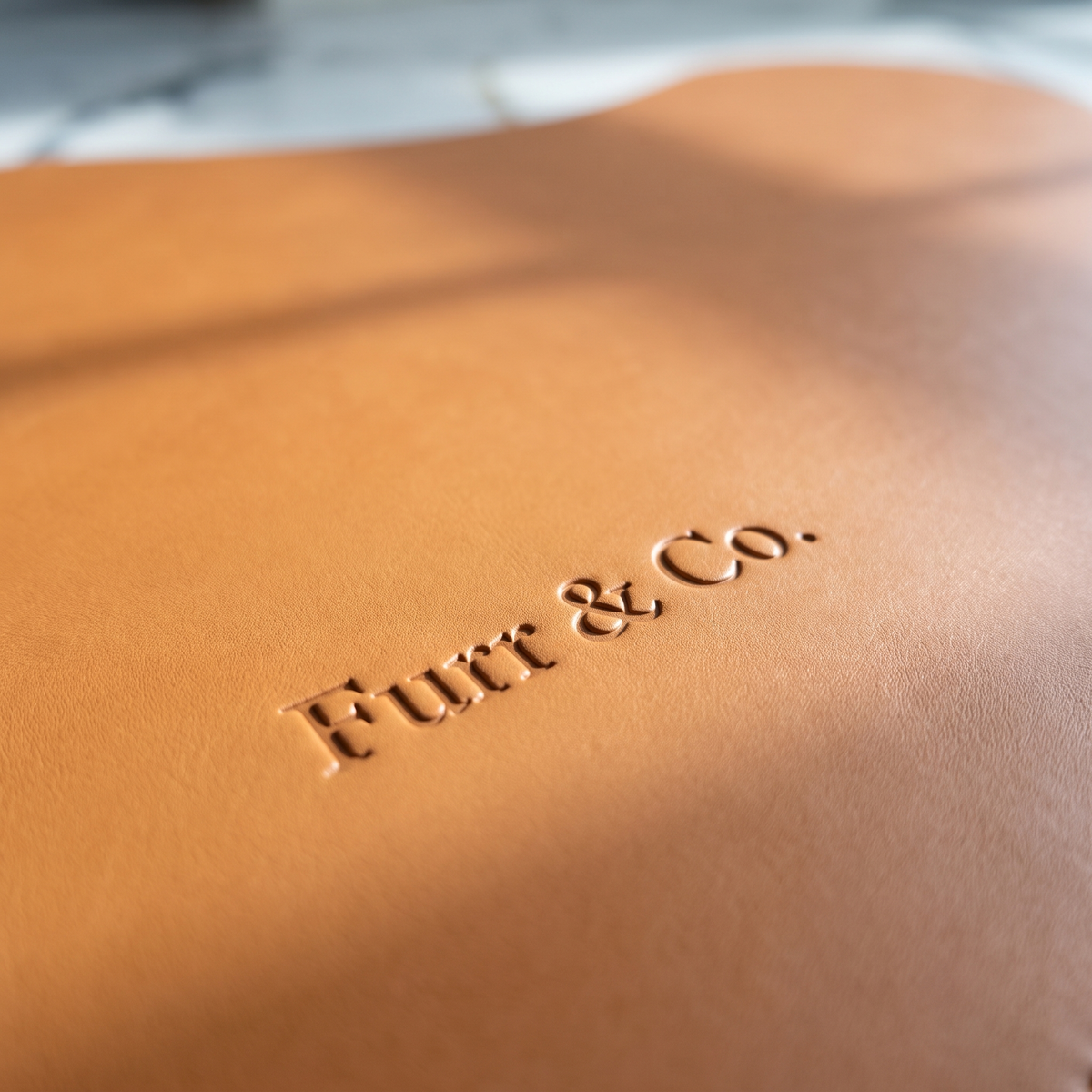 Close view of the debossed Furr & Co. wordmark on the Beaumont Placemat