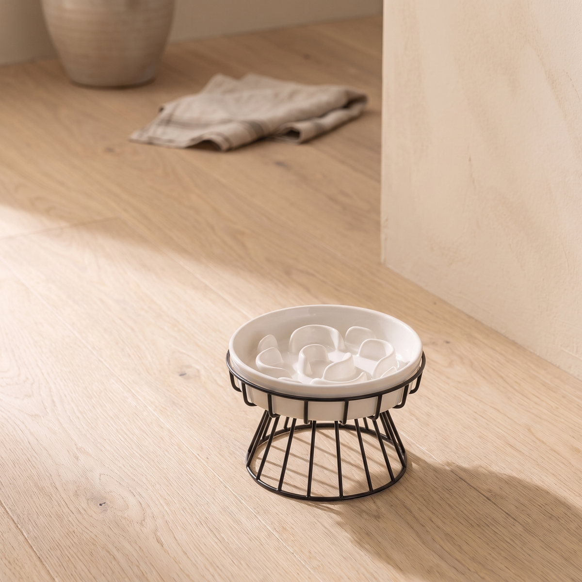 Lumière Slow Feeder Bowl on a pale oak floor against a cream plastered wall