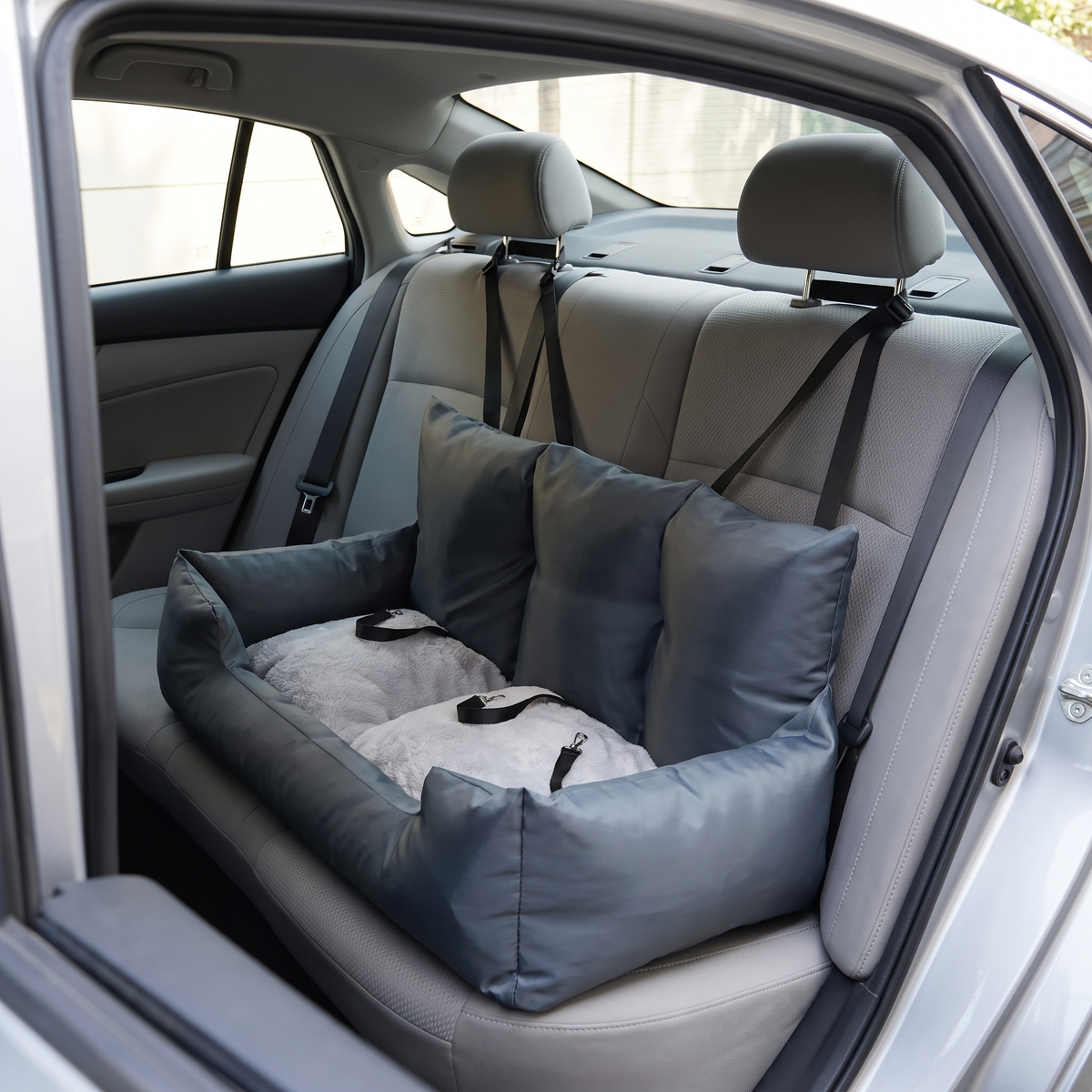 Strada Car Seat installed on a car's rear bench, straps looped over the headrests